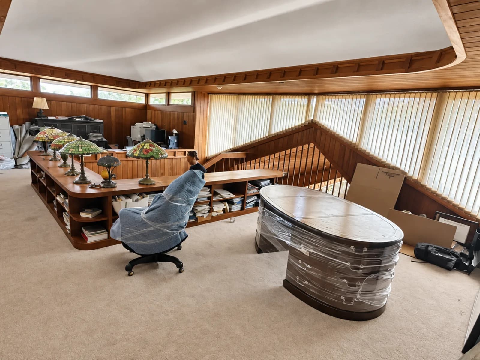 A modern office interior with desks and chairs wrapped for a commercial relocation